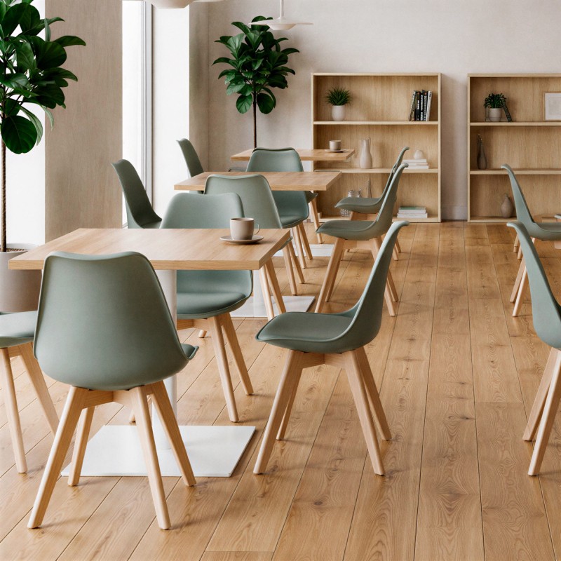 Silla escandinava Ada verde en una cafetería